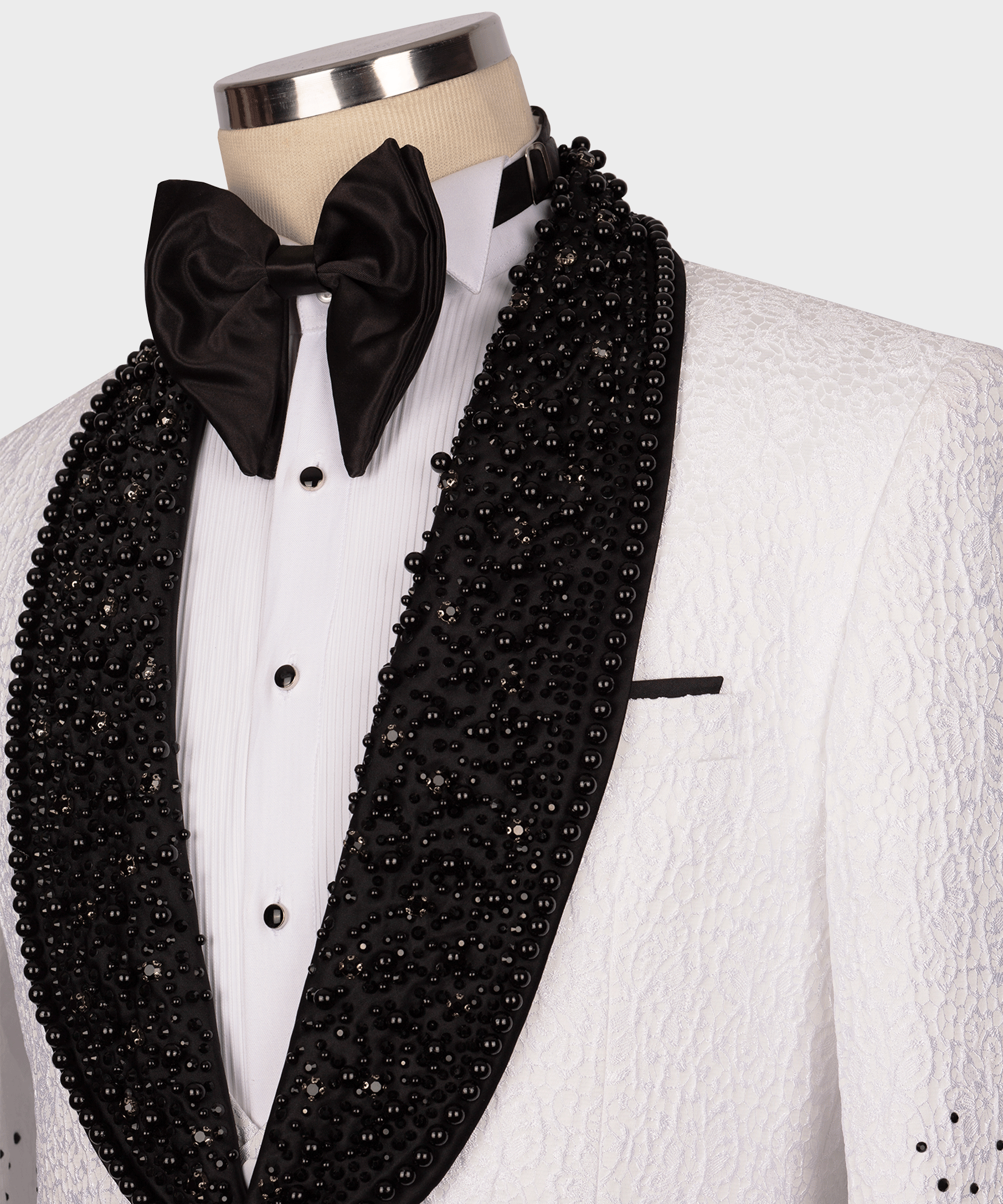 Close-up of black gem-embellished tuxedo lapel with black satin bow tie