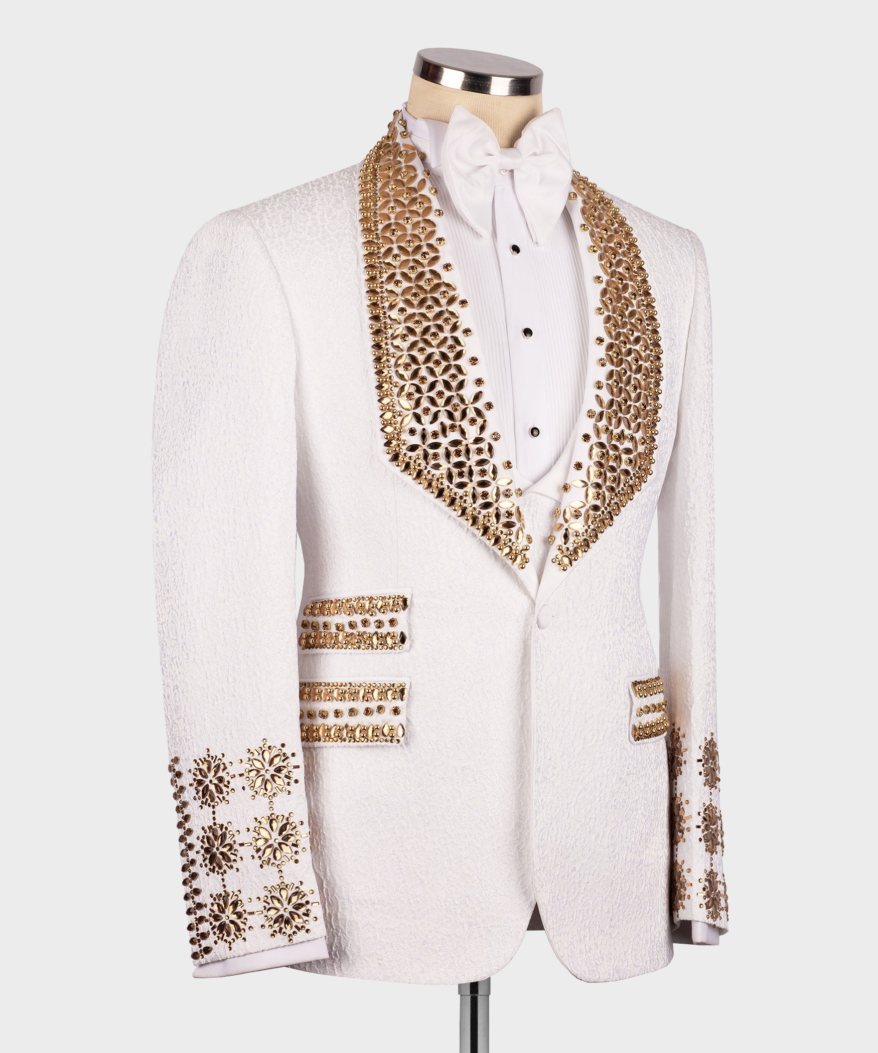 White tuxedo with gold beaded lapel, jeweled cuffs, vest and bow tie