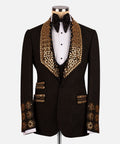 Black tuxedo jacket with gold gem-like trim on lapels, cuffs, and pockets; black bow tie