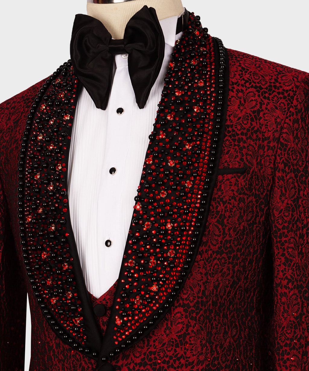 Red sequined tuxedo with black beaded lapels, white shirt, and large black bow tie