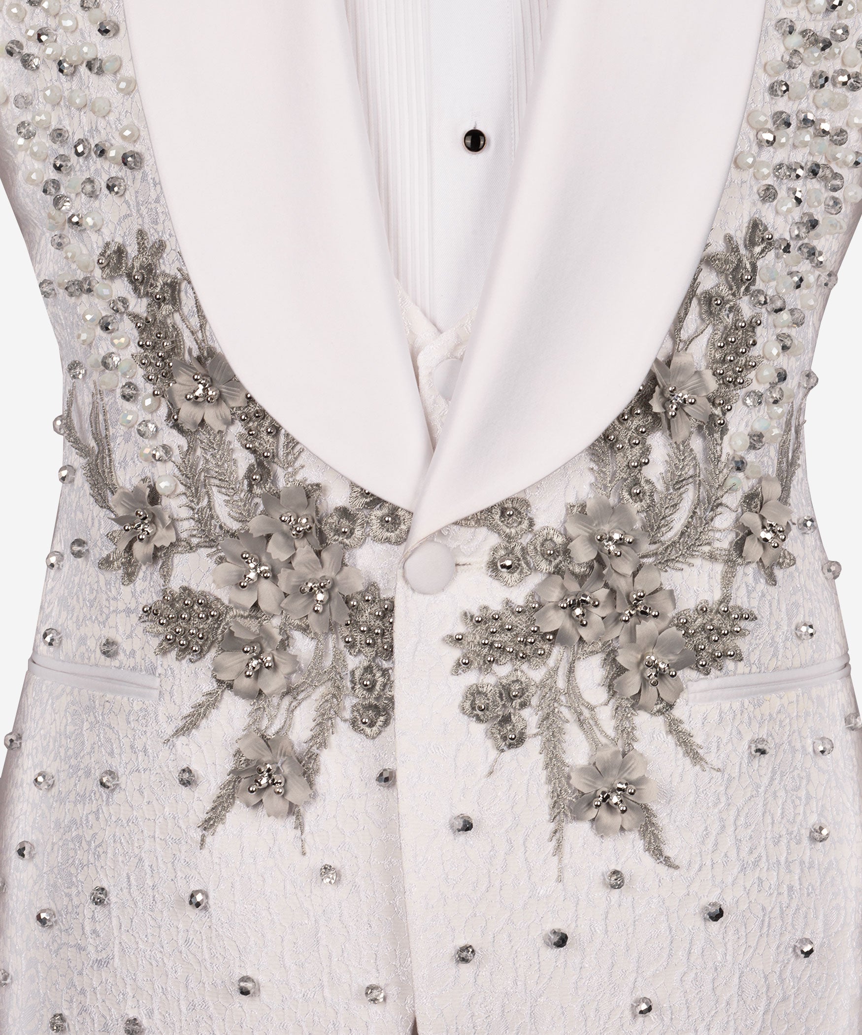 Close-up: white tuxedo vest with jeweled floral applique and rhinestone buttons