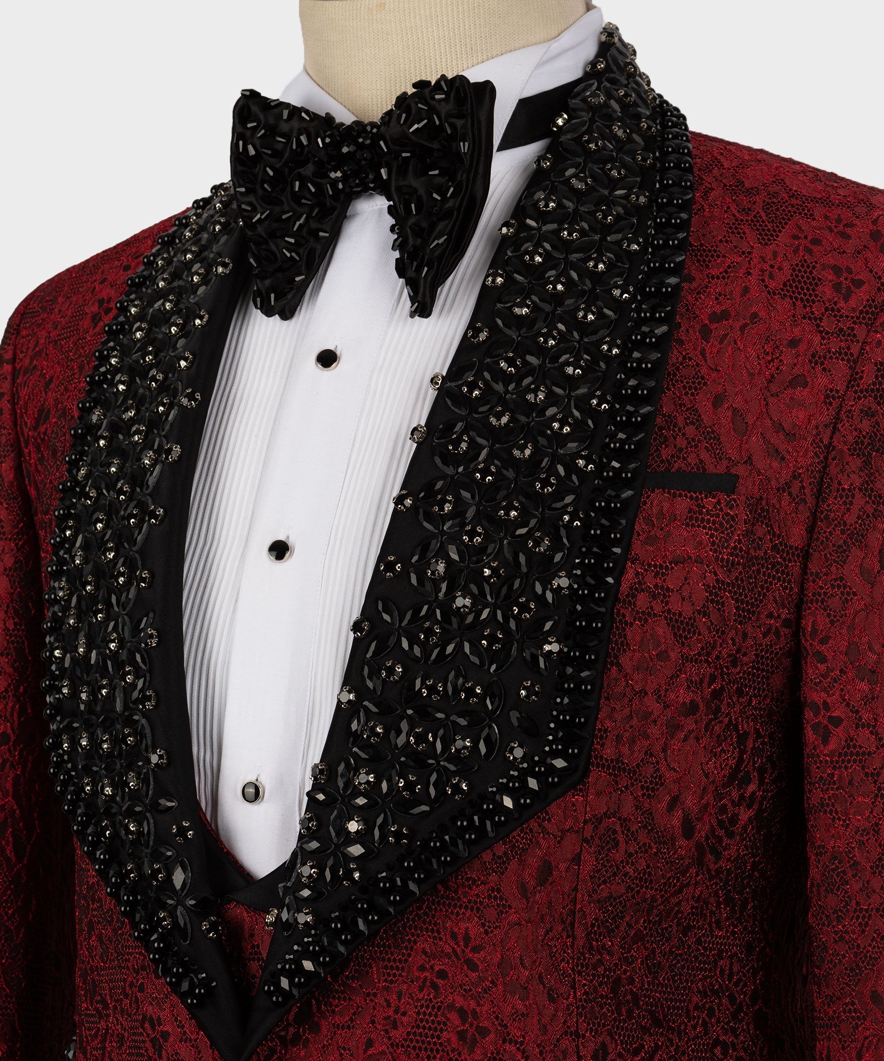 Close-up: black embellished bow tie and lapels over a white dress shirt