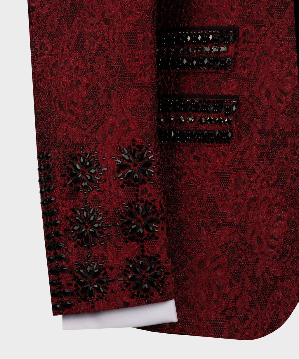 Close-up of red tuxedo sleeve and pocket with black decorative button details