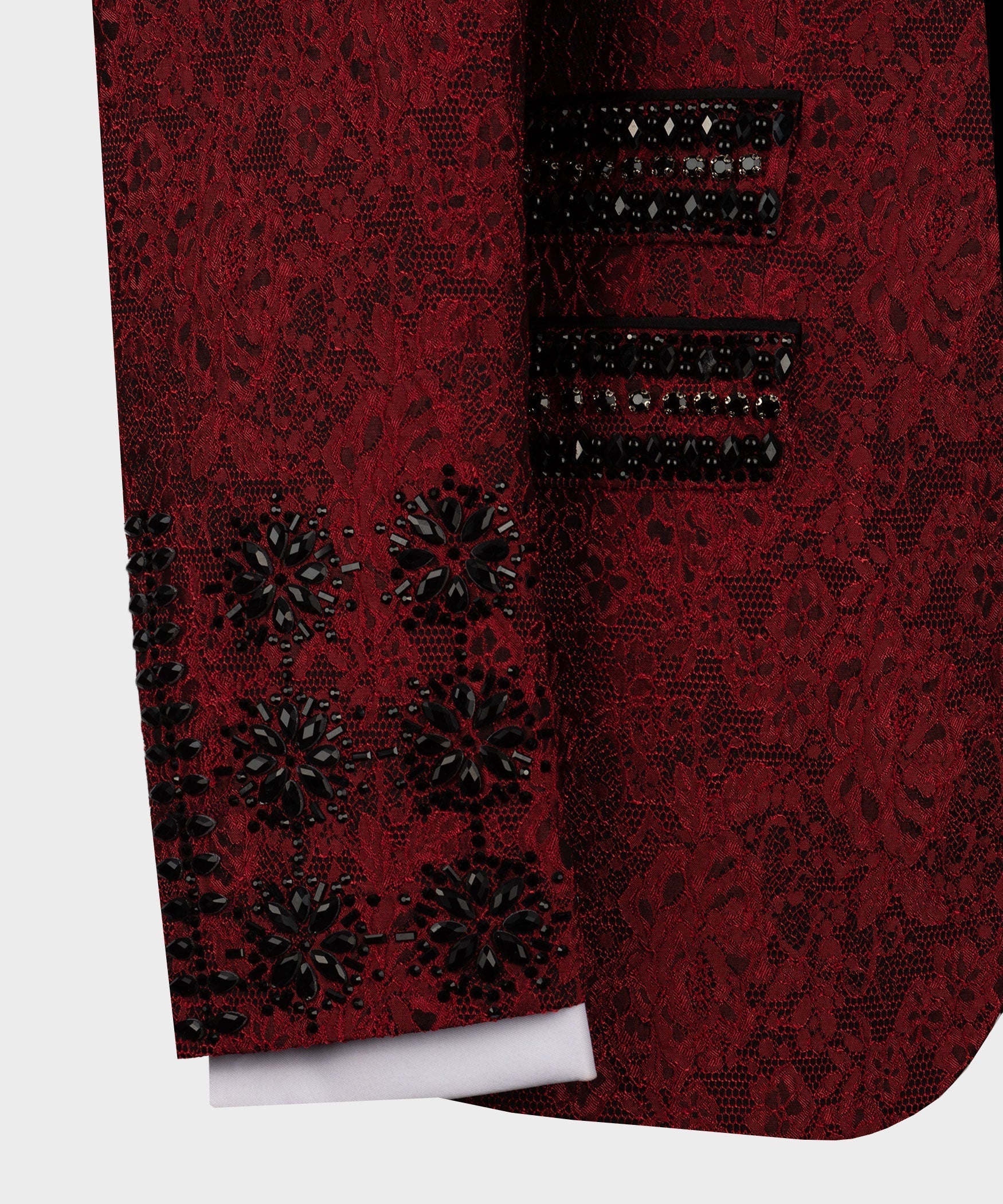 Close-up of red tuxedo sleeve and pocket with black decorative button details