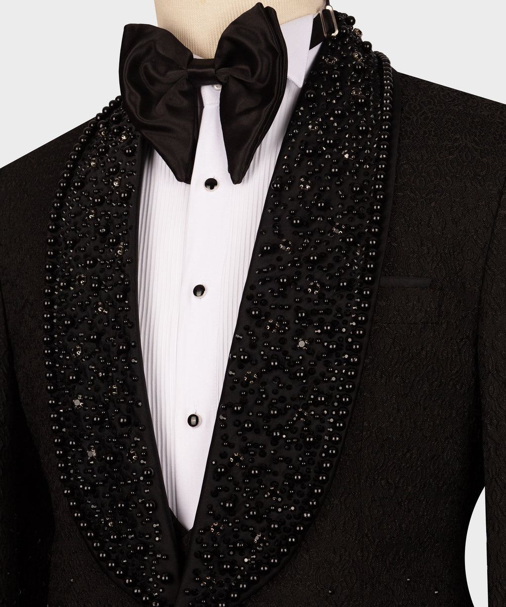Black tuxedo with oversized black bow, white pleated shirt, and rhinestone lapels