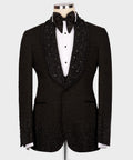 Black tuxedo jacket with rhinestone lapels, bow tie, and white dress shirt