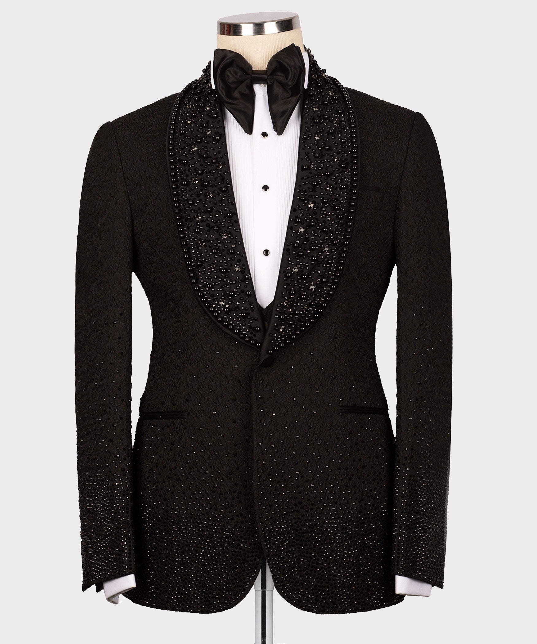 Black tuxedo jacket with rhinestone lapels, bow tie, and white dress shirt