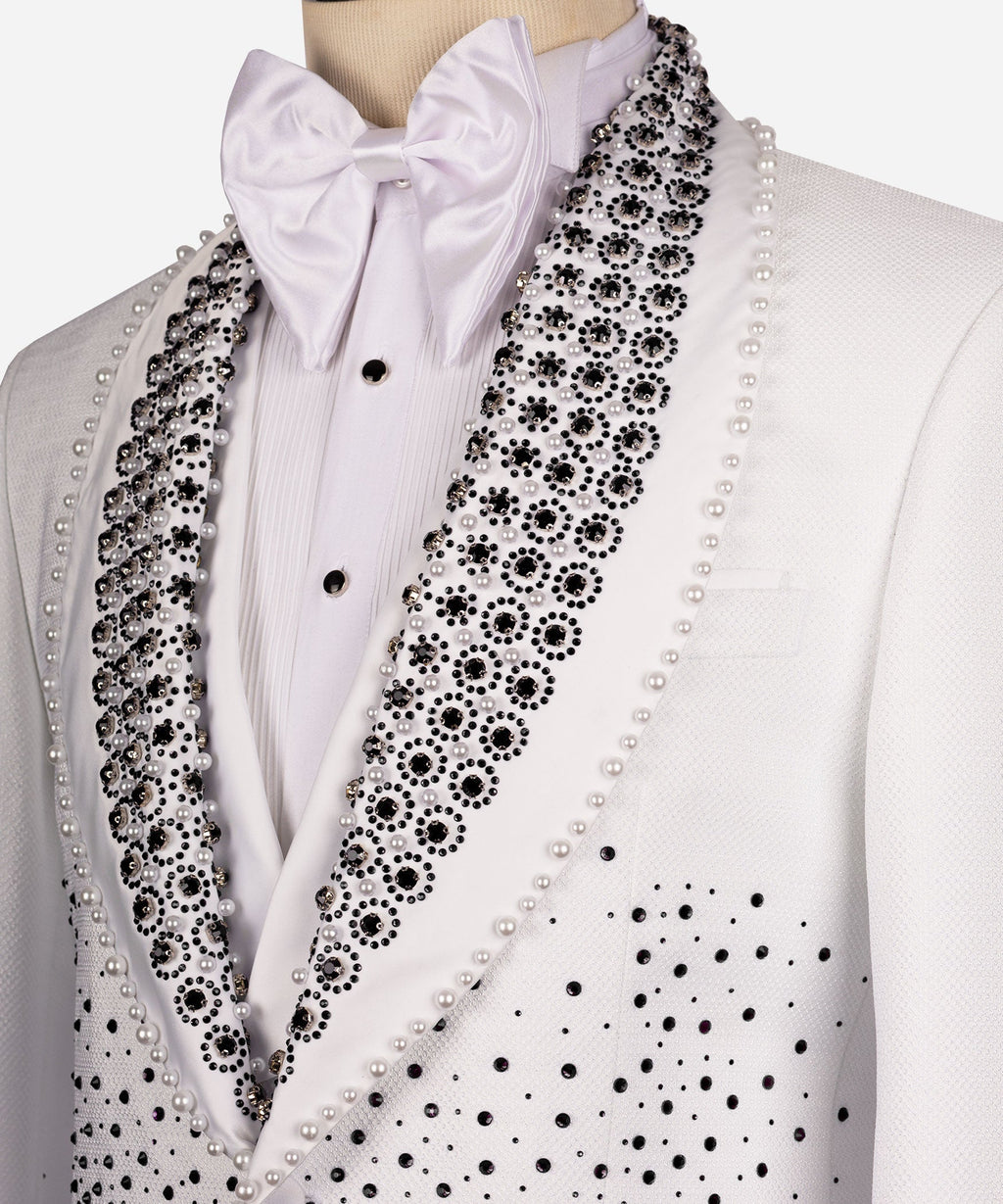 Close-up white tuxedo lapel with black gems and pearl trim, satin bow tie