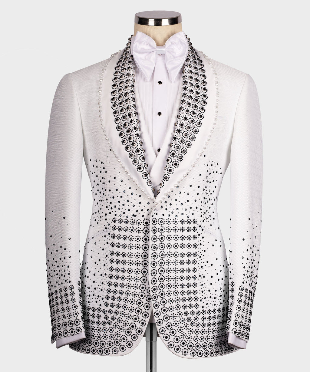 White tuxedo jacket with black gem-studded lapels, bow tie, and patterned front