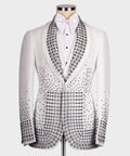 White tuxedo jacket with black gem-studded lapels, bow tie, and patterned front