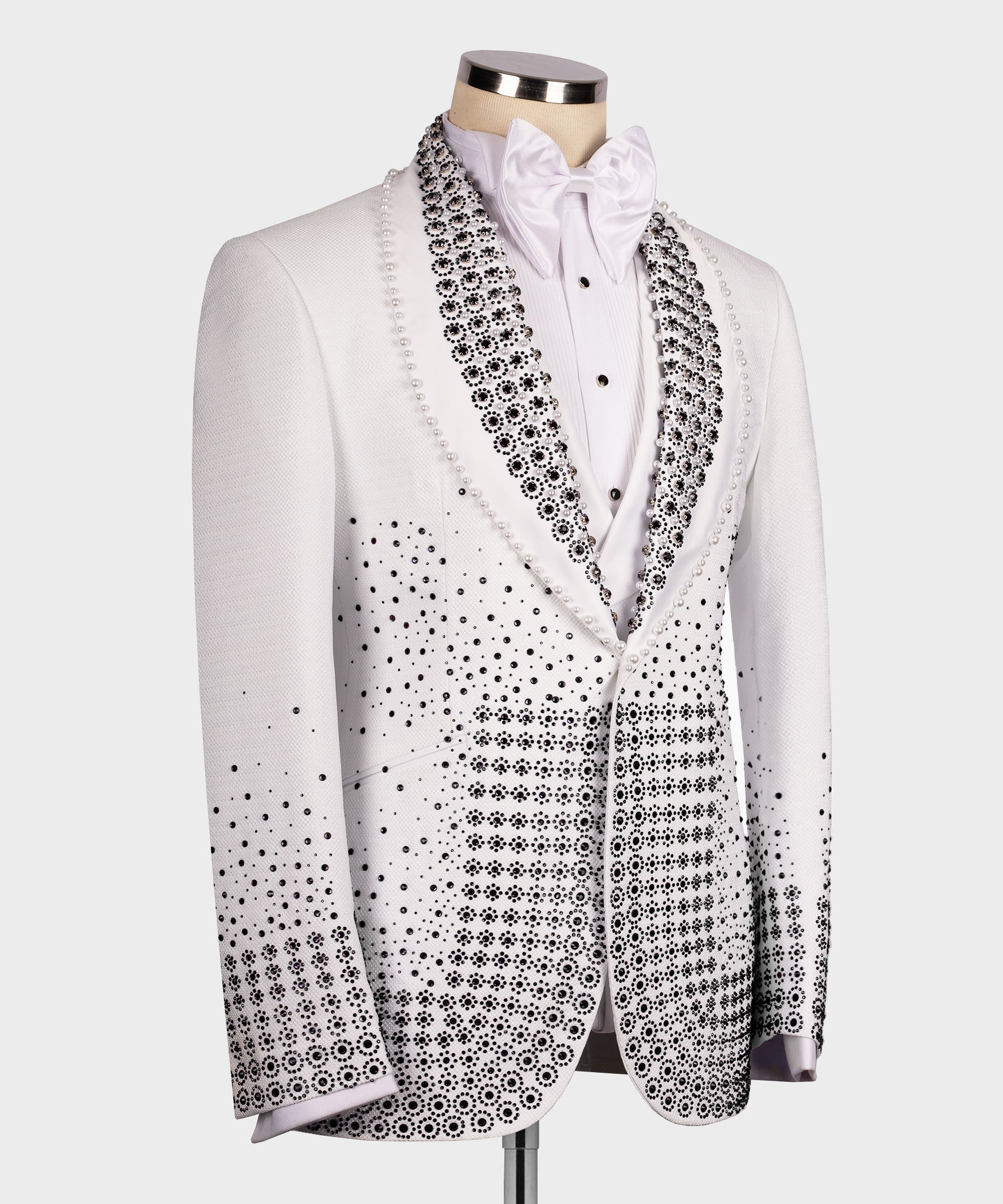 Front view white tuxedo with black beaded detailing, satin bow tie, and buttoned placket