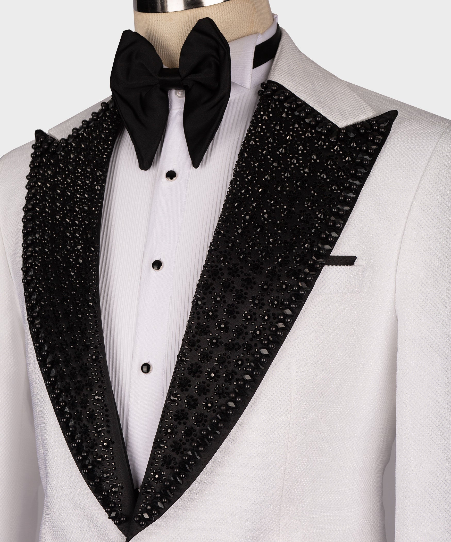 Close-up white shirt and black sequin lapels with large black bow tie