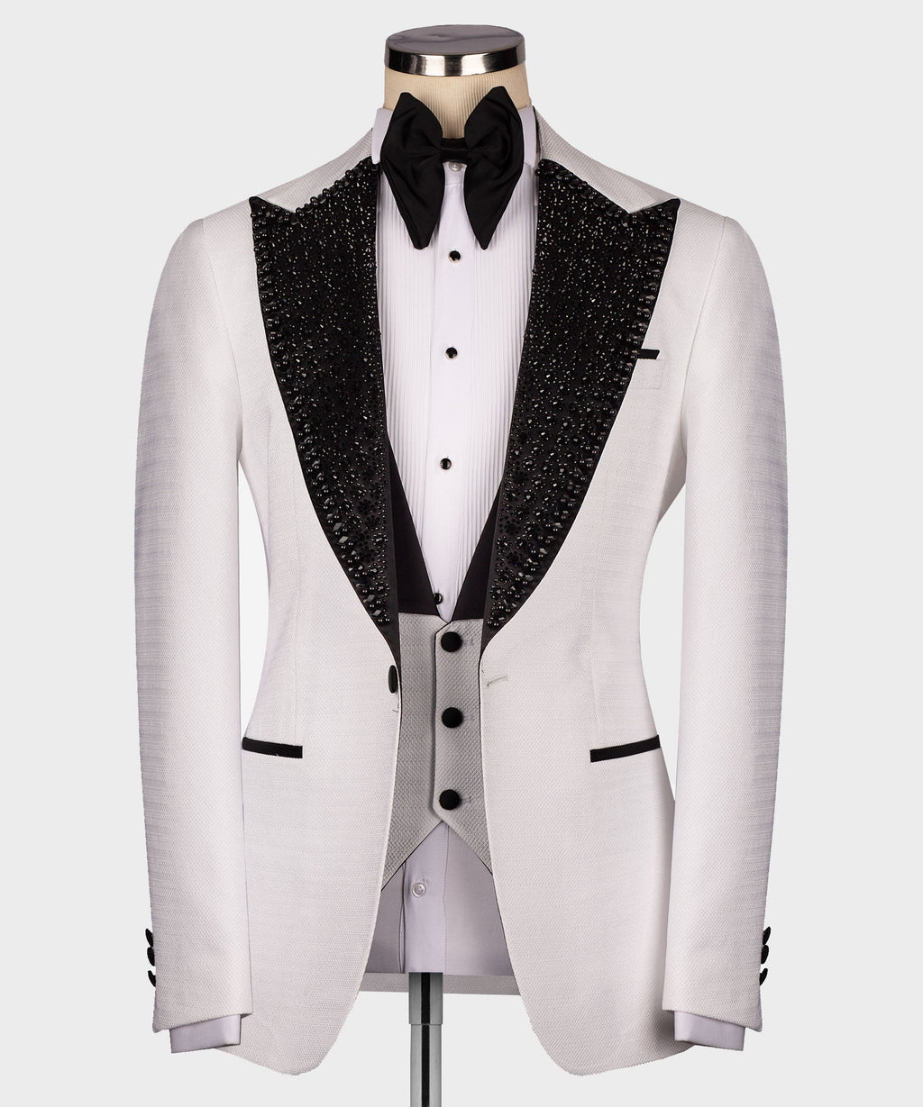 Front view white tuxedo jacket with black sequin lapels, white shirt, black bow tie