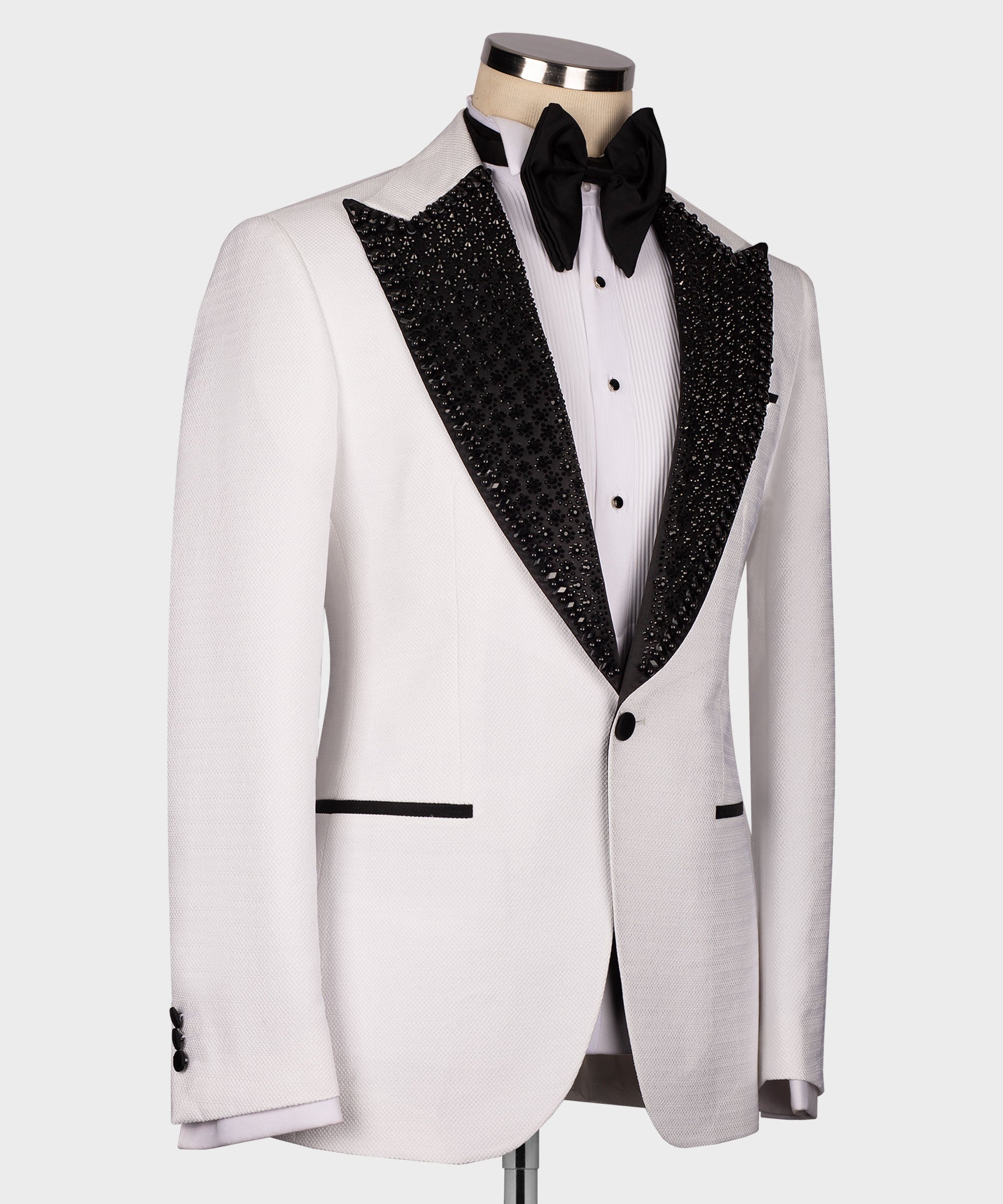 White tuxedo jacket with black glitter lapel trim and black bow tie, side angle