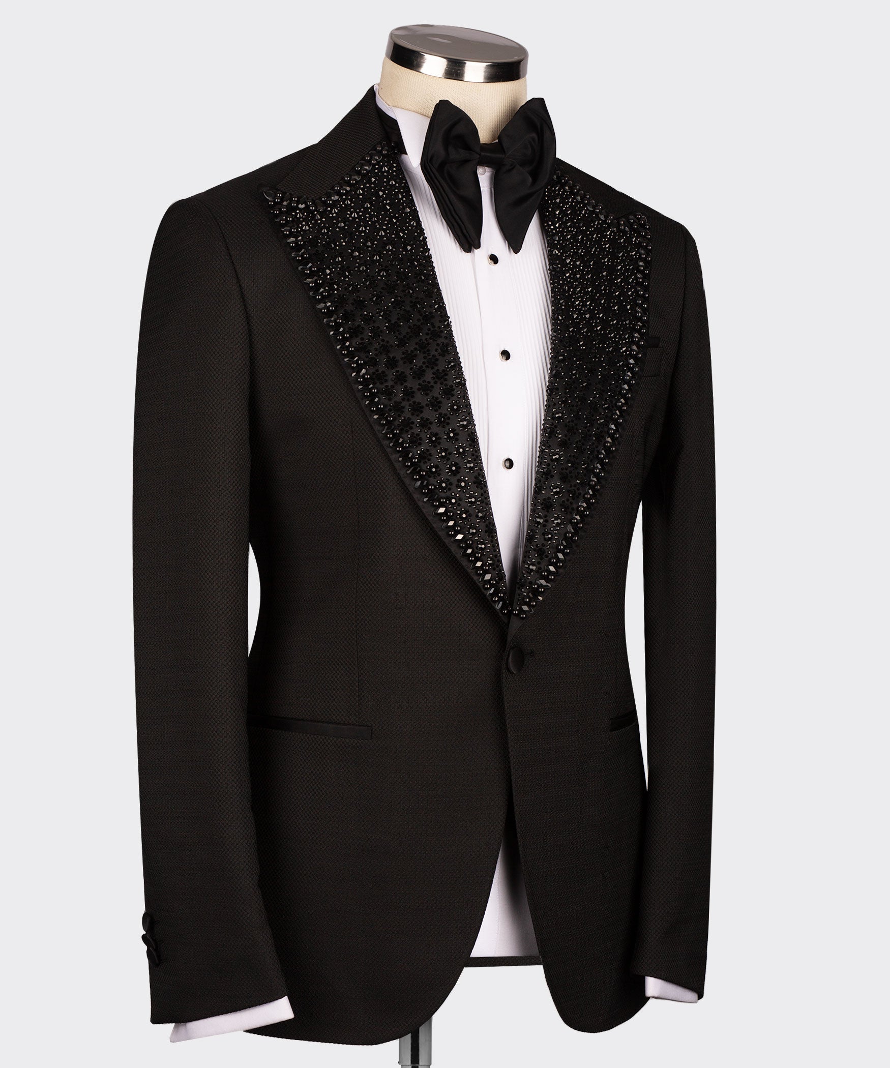 Black tuxedo jacket with jeweled shawl lapel, black bow tie, satin-style lapels