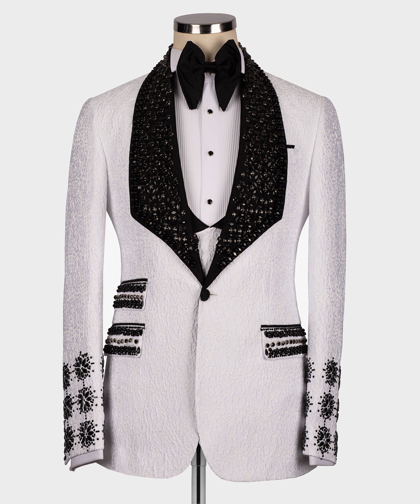 White tuxedo jacket with black gem-studded lapels and crystal button details