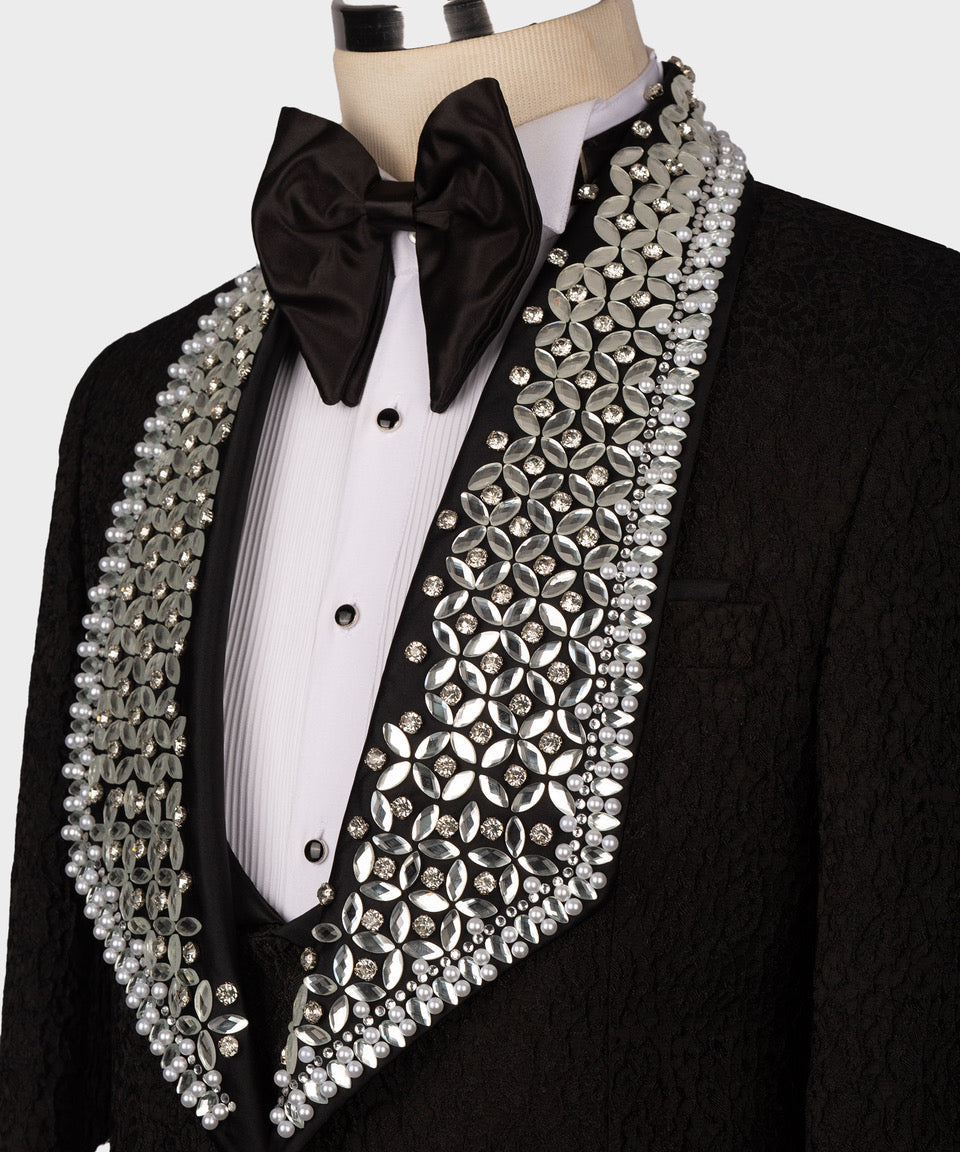 Black tuxedo jacket front with satin bow tie and ornate gem and pearl-like trim