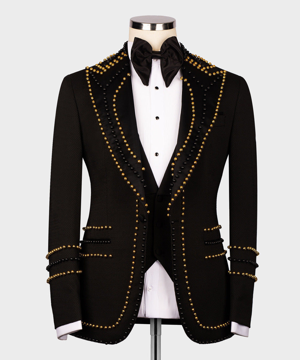 Black tuxedo jacket front view with layered gold bead V-trim and decorative shirt buttons