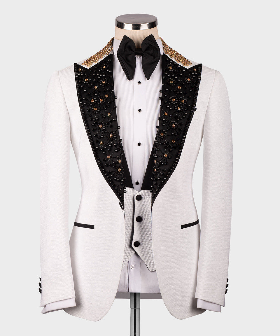 White tuxedo with black crystal-style lapels and gold edge trim, bow tie and vest front