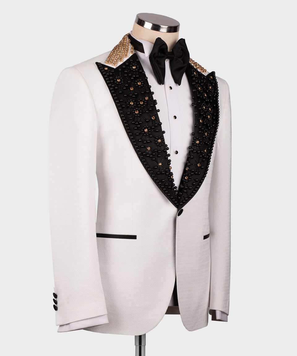 White tuxedo jacket front with black embellished V-lapel, gold trim on shoulders