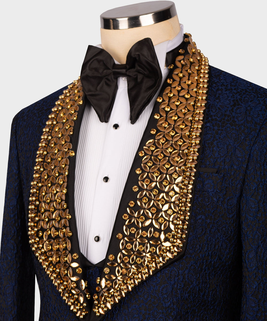 Close-up tuxedo: black bow tie, white shirt front, and gold gem-like lapel detailing