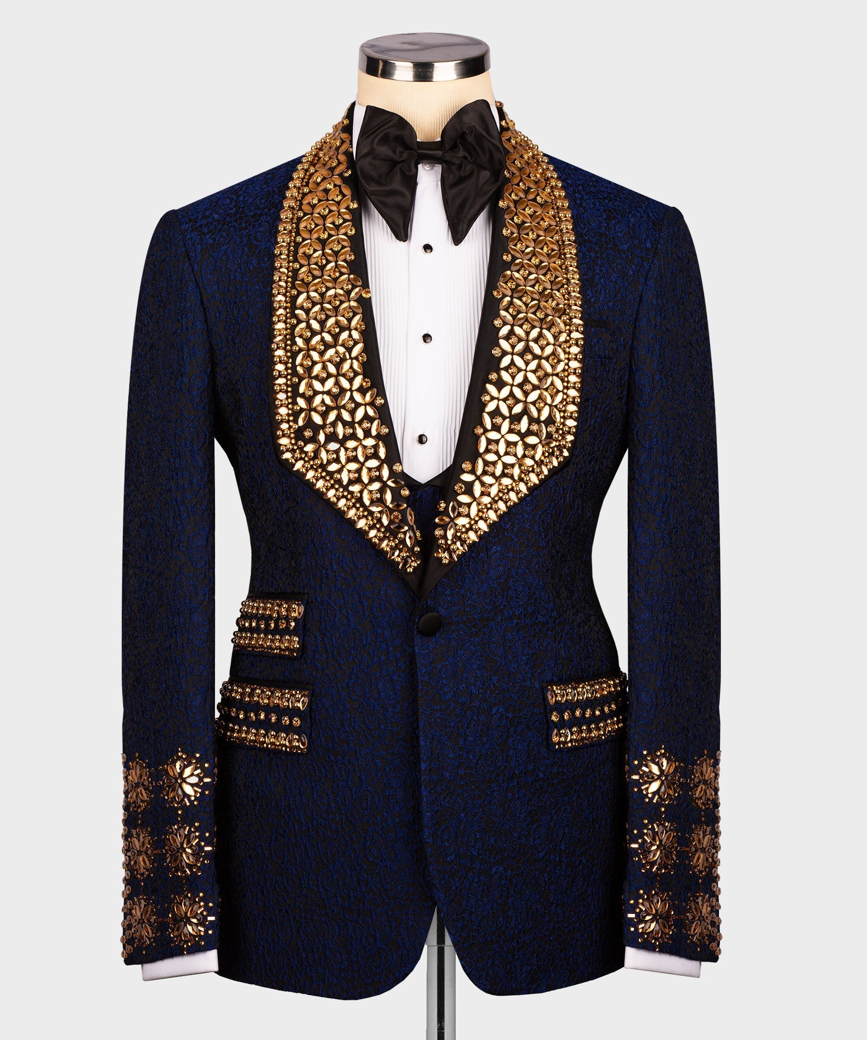 Dark navy tuxedo jacket with gold embellished lapels and black bow tie