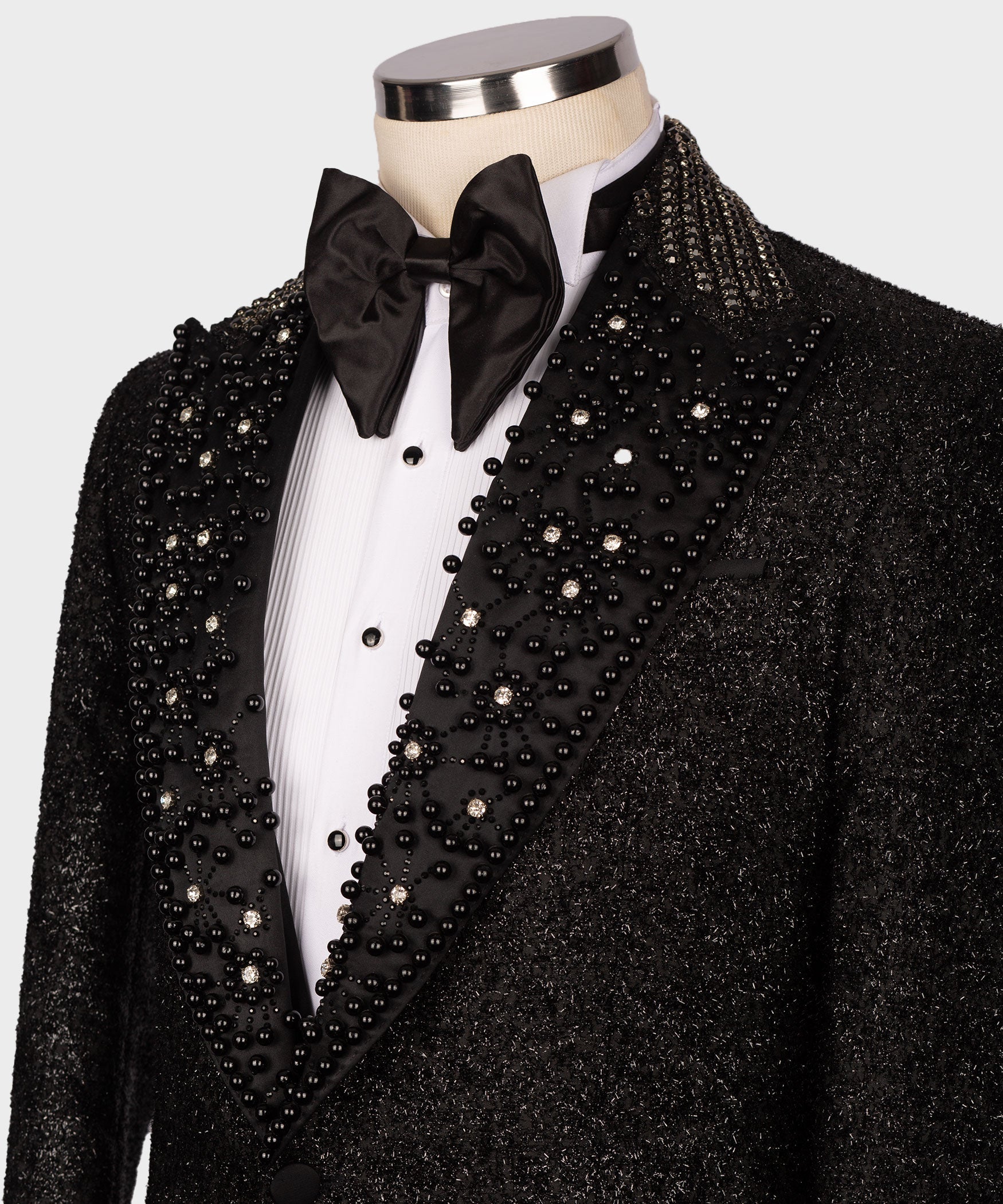 Close-up black tuxedo lapel and waistcoat with dense crystal bead embellishment