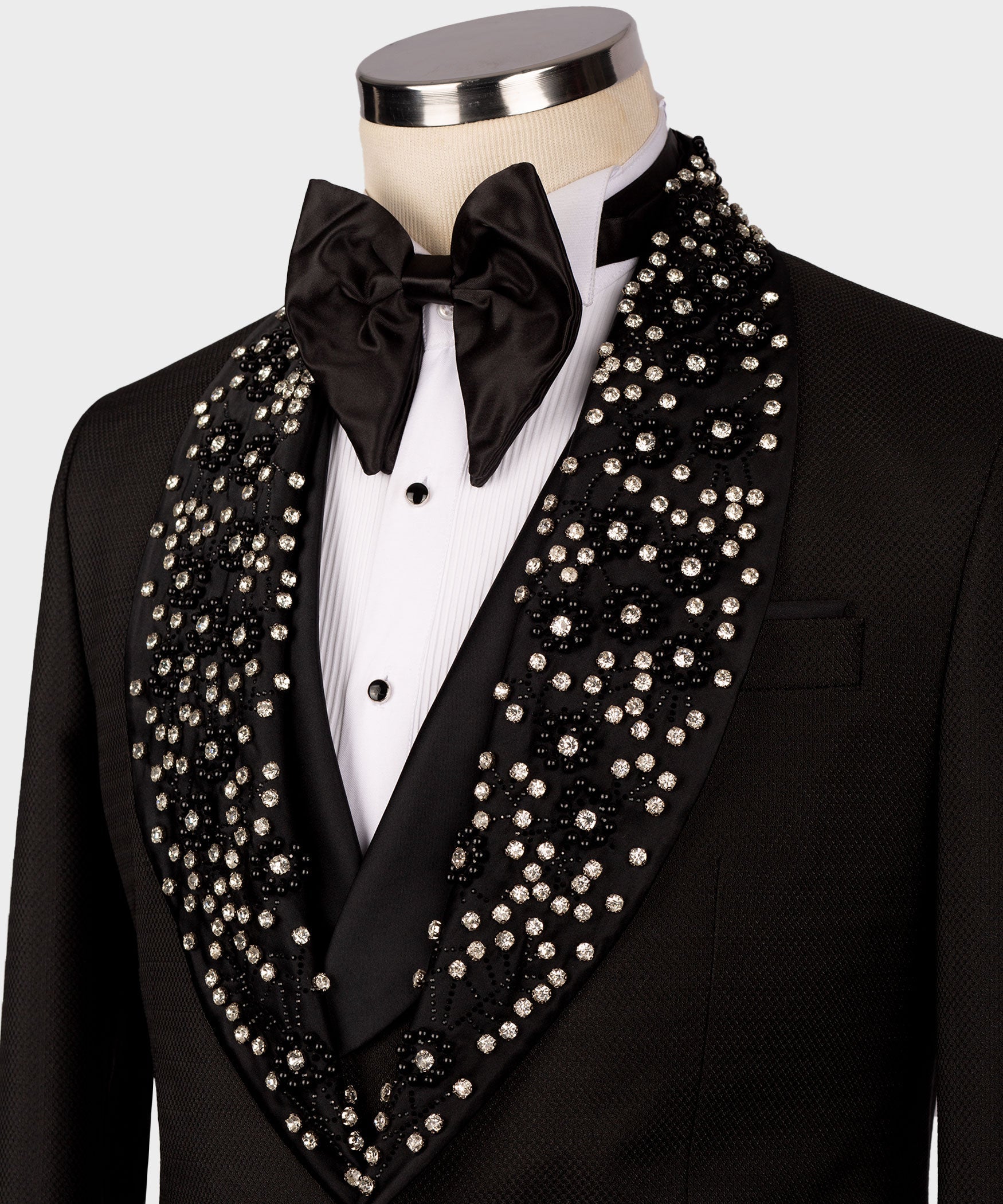 Close-up: black tuxedo with satin bow tie and rhinestone-trim lapels