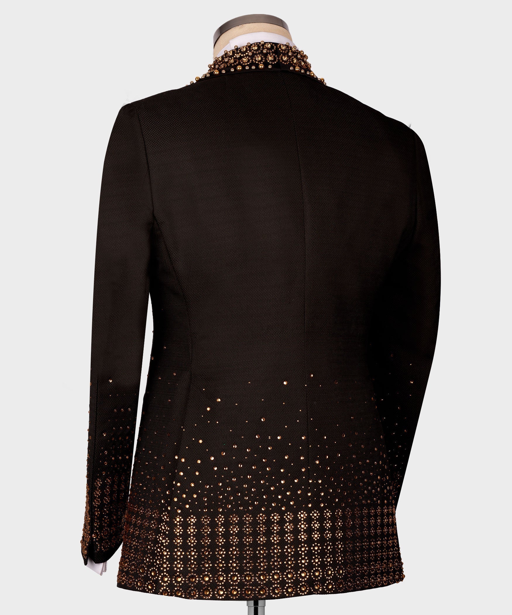 Back view of black tuxedo jacket with gold gem-like trim on cuffs and hem