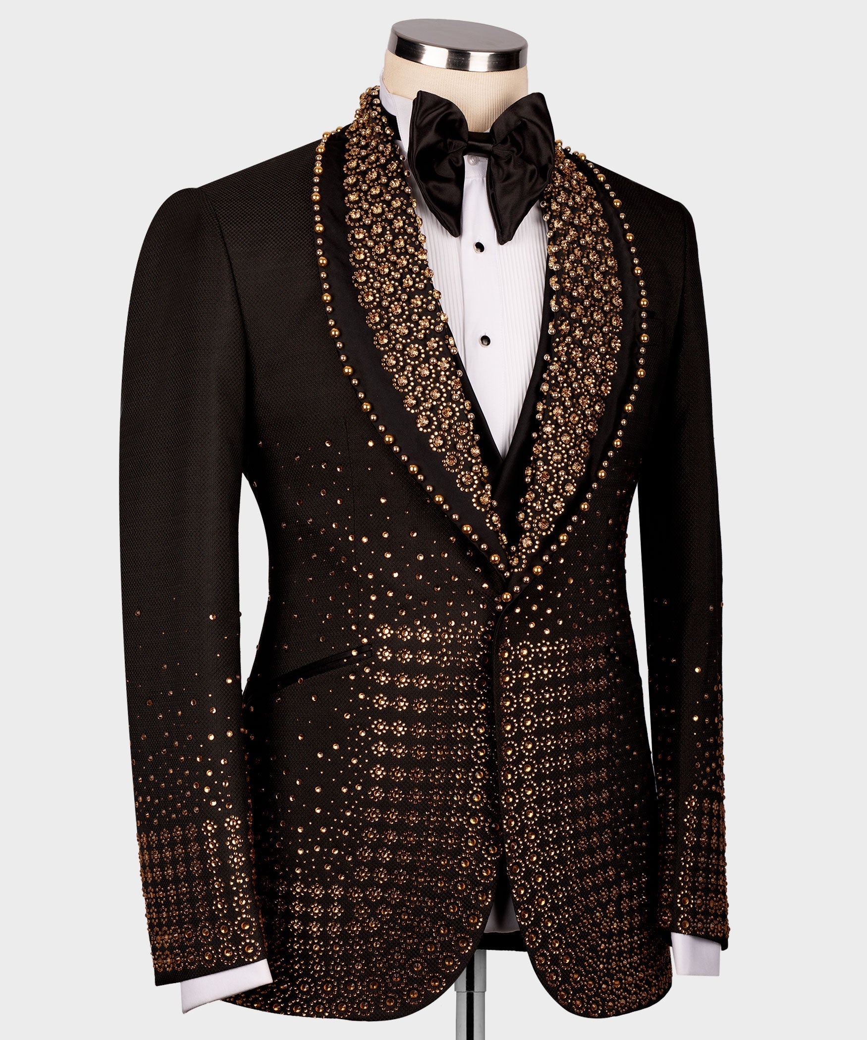 Black tuxedo jacket with gold gem-like detailing along lapels and chest, front view