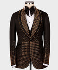 Black tuxedo jacket with dense gold gem-like trim on lapels and front panels, bow tie