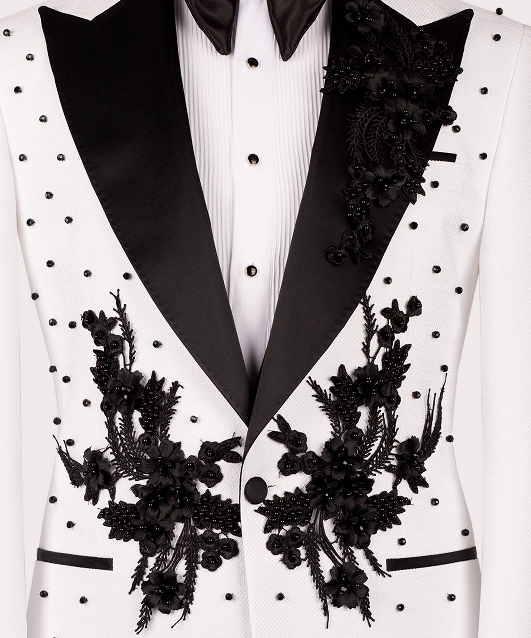 Black floral embroidered motifs on white tuxedo lapels with black satin edge trim