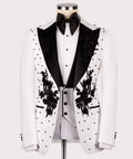 White tuxedo jacket front with black satin lapels, floral embroidery, and dot pattern
