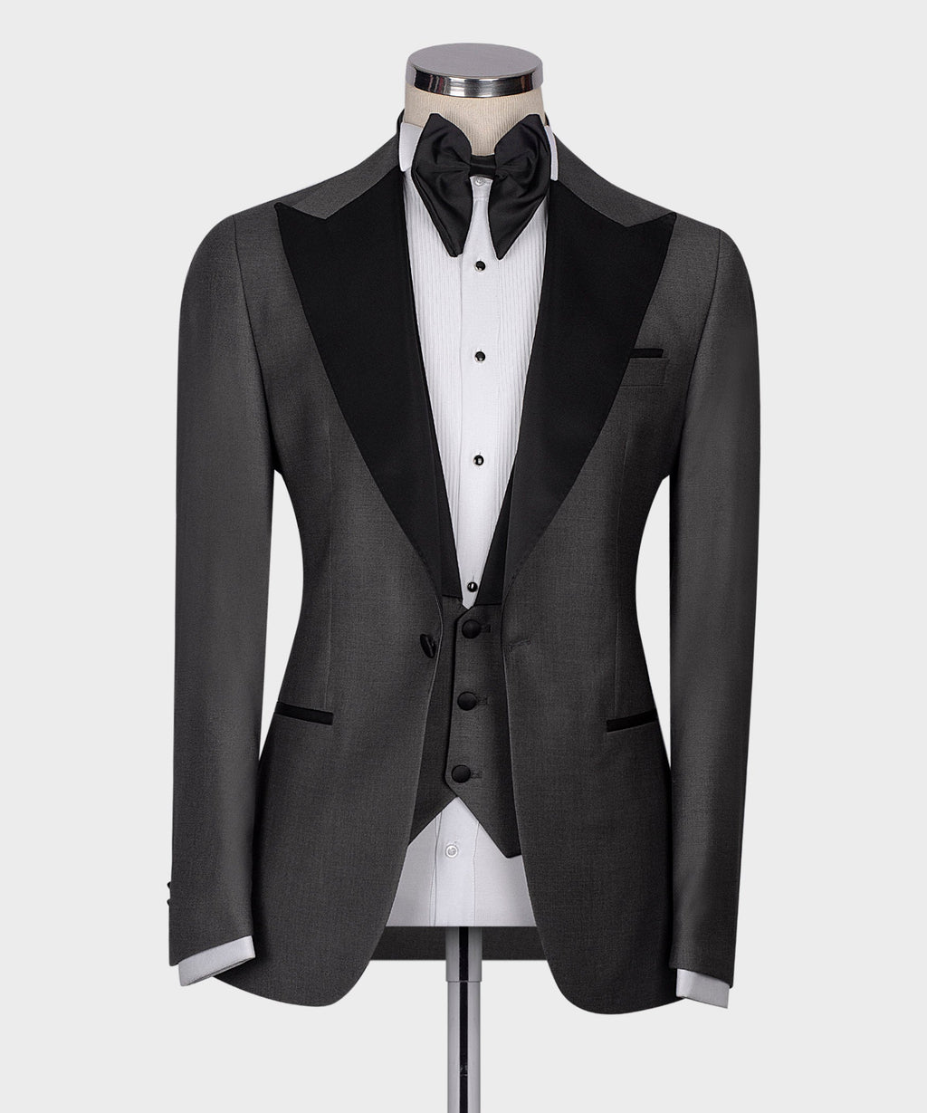 Charcoal gray tuxedo jacket with black satin lapels, bow tie, and white dress shirt