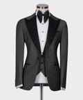Charcoal gray tuxedo jacket with black satin lapels, bow tie, and white dress shirt