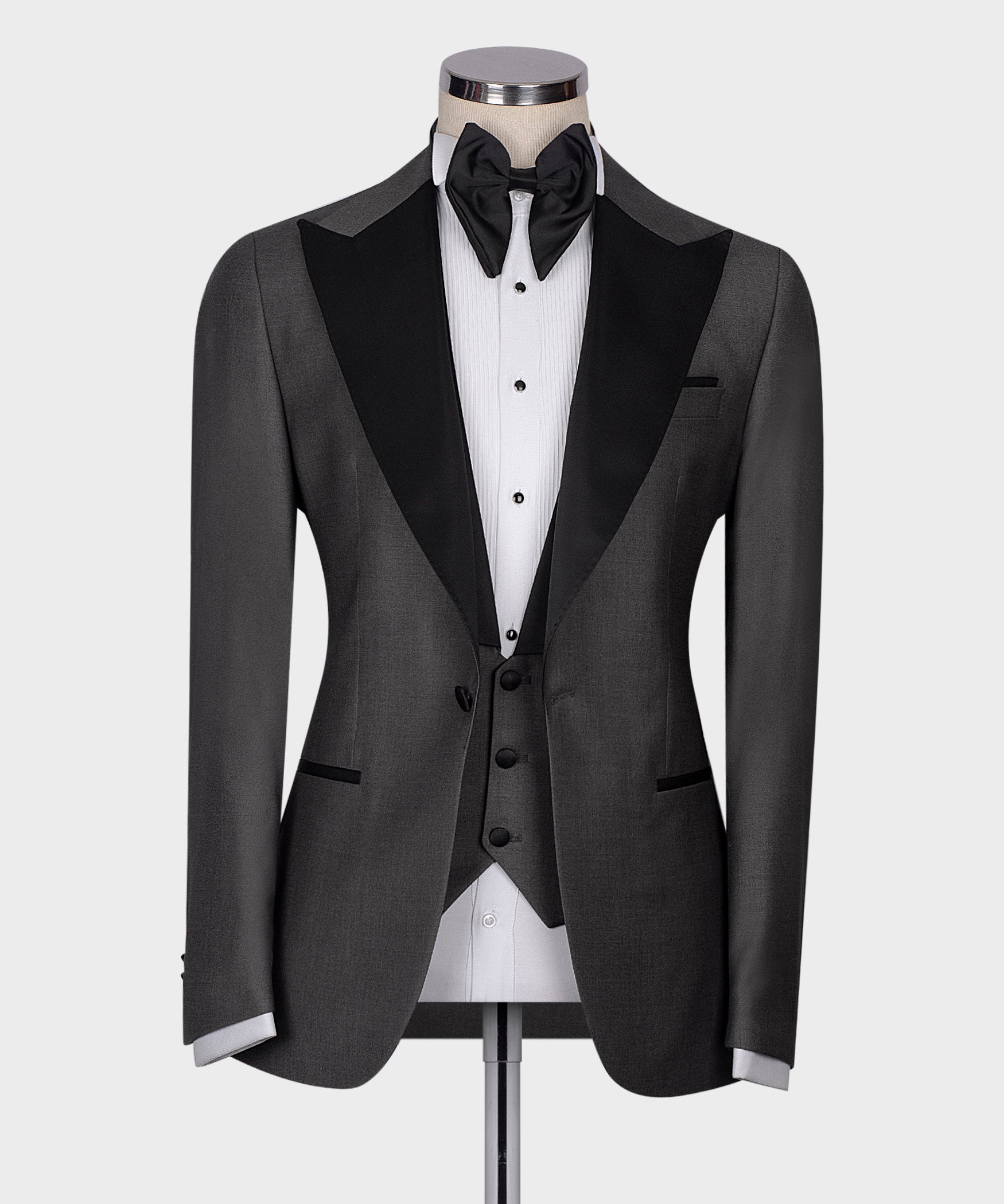 Charcoal gray tuxedo jacket with black satin lapels, bow tie, and white dress shirt