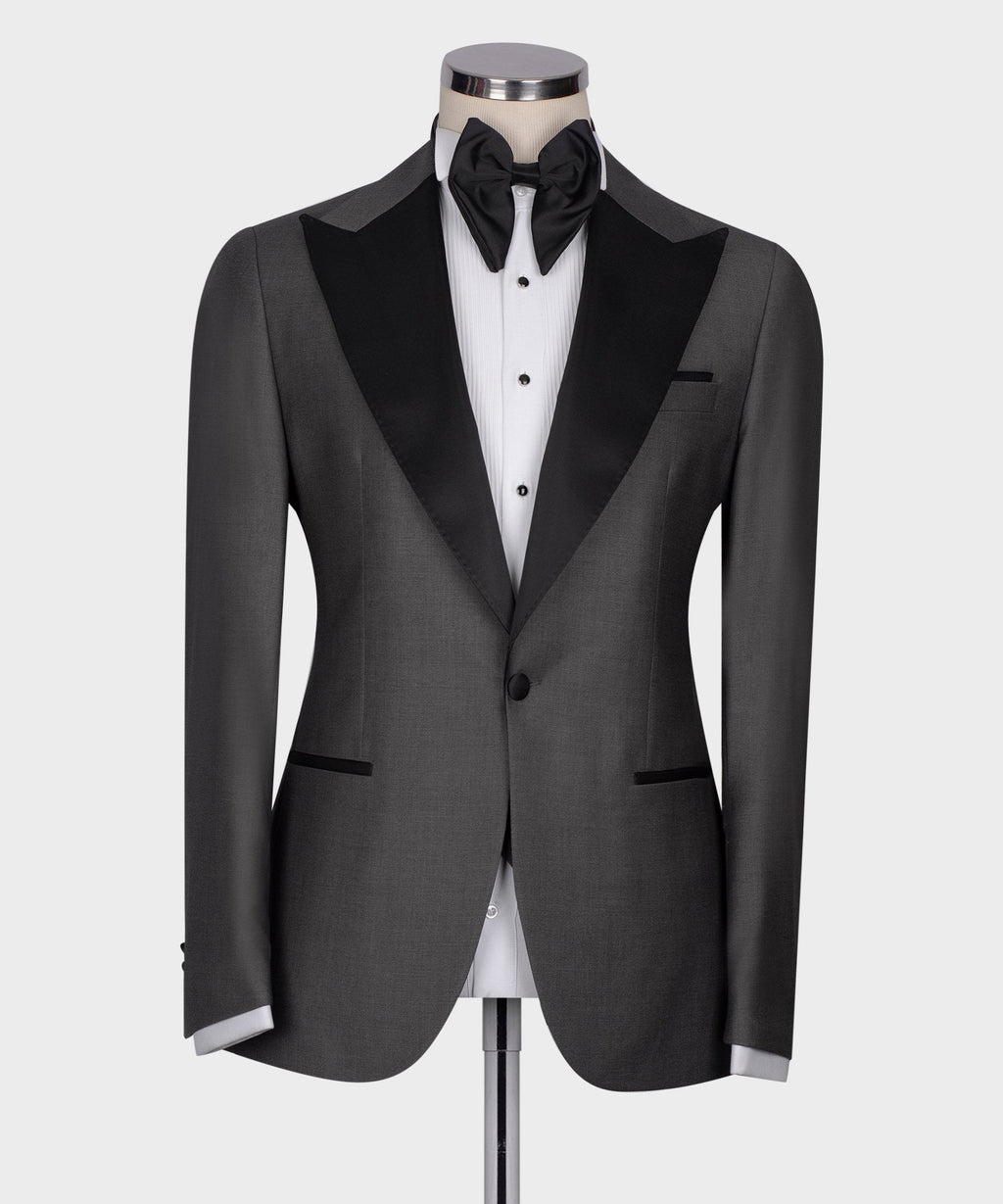 Charcoal gray tuxedo jacket front with black shawl lapels and white striped dress shirt