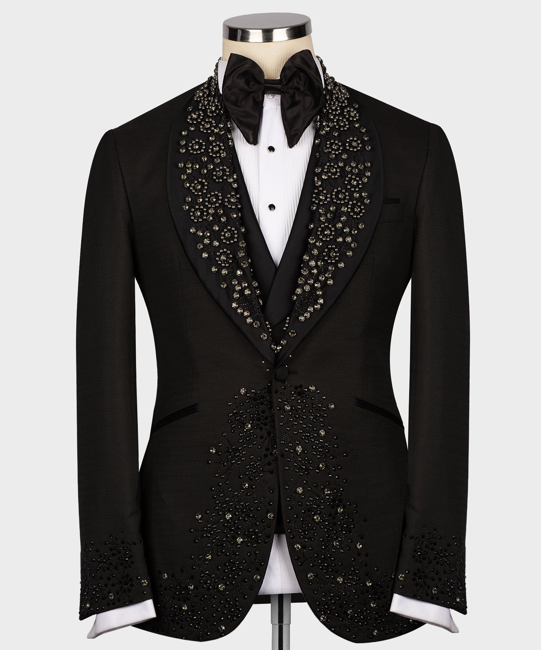 Black custom tuxedo jacket with jeweled lapel detailing, satin bow tie, and white shirt