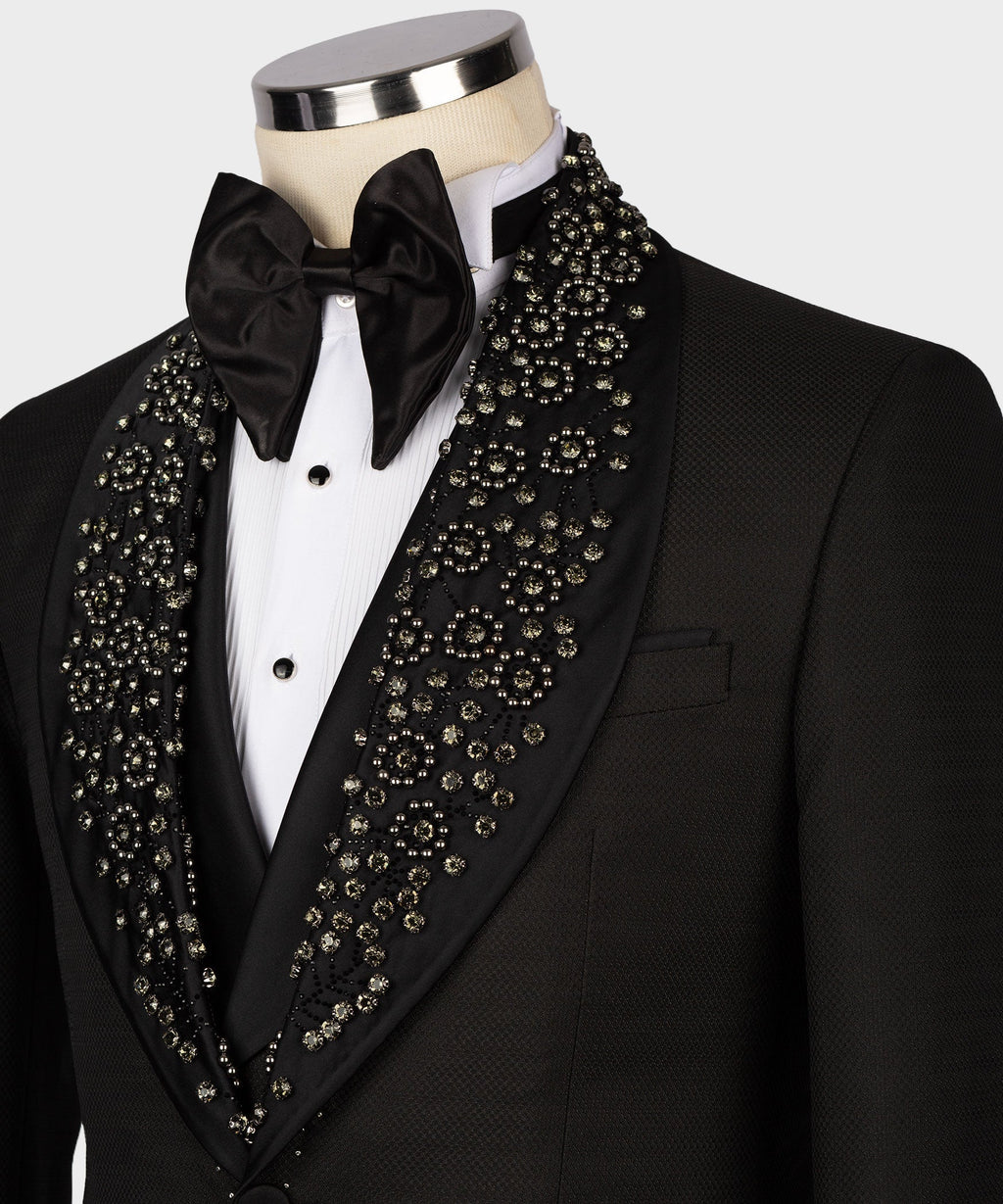 Close-up: black tuxedo bow tie and jeweled lapel trim over white shirt placket