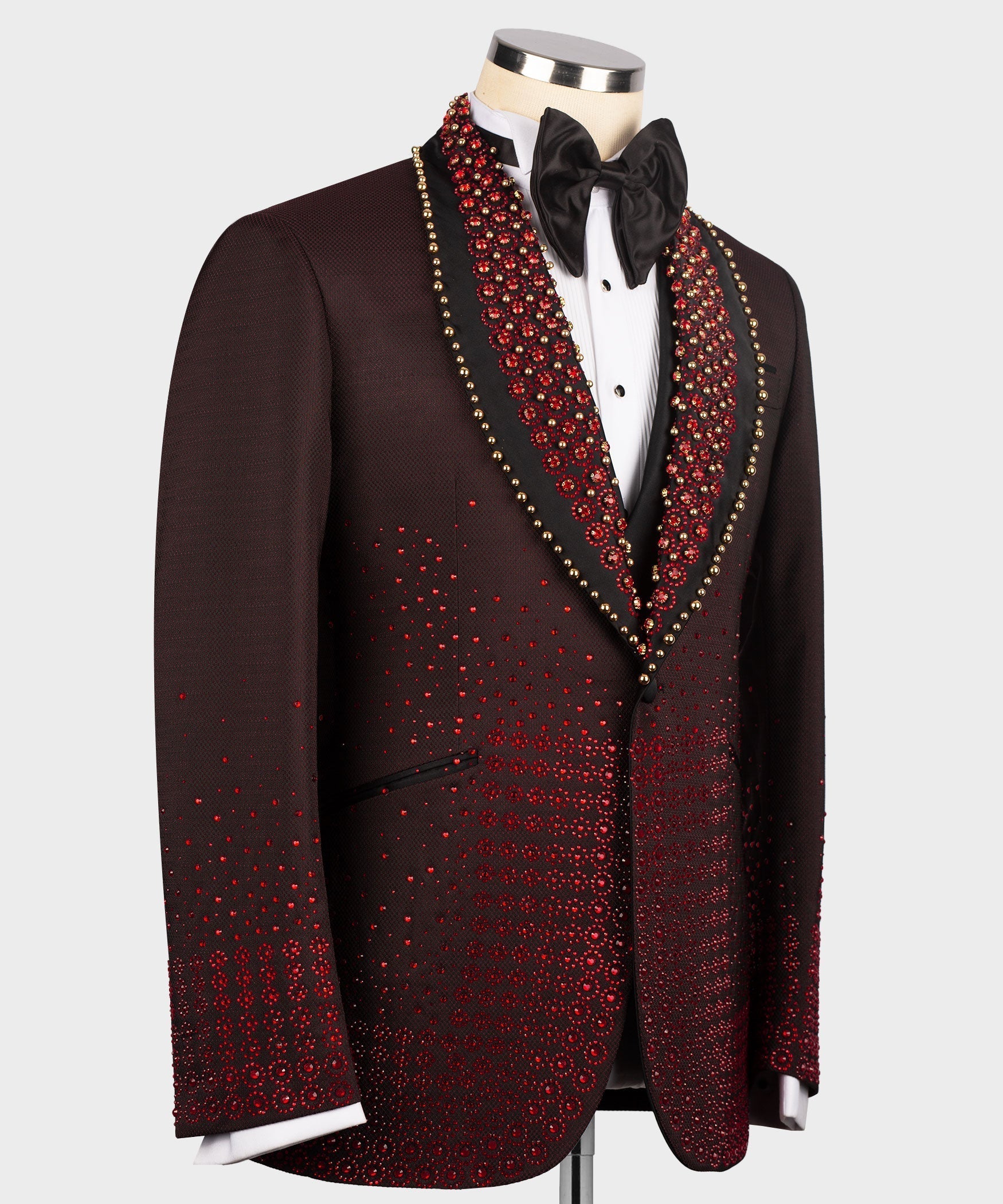 Burgundy tuxedo jacket front with black satin bow tie, red patterned trim, and two pockets