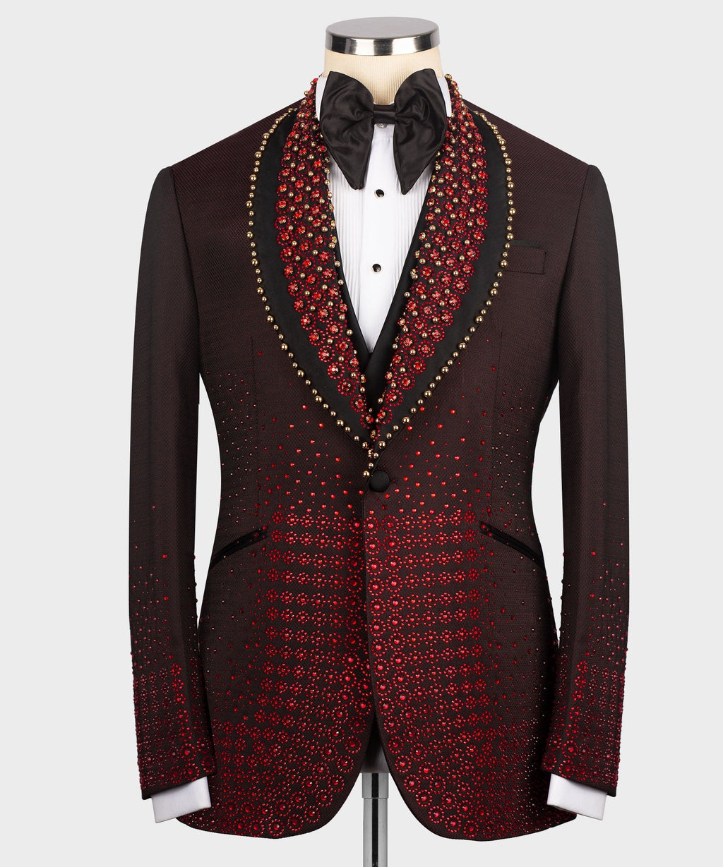 Burgundy tuxedo jacket with red and gold patterned lapels, black bow tie and vest