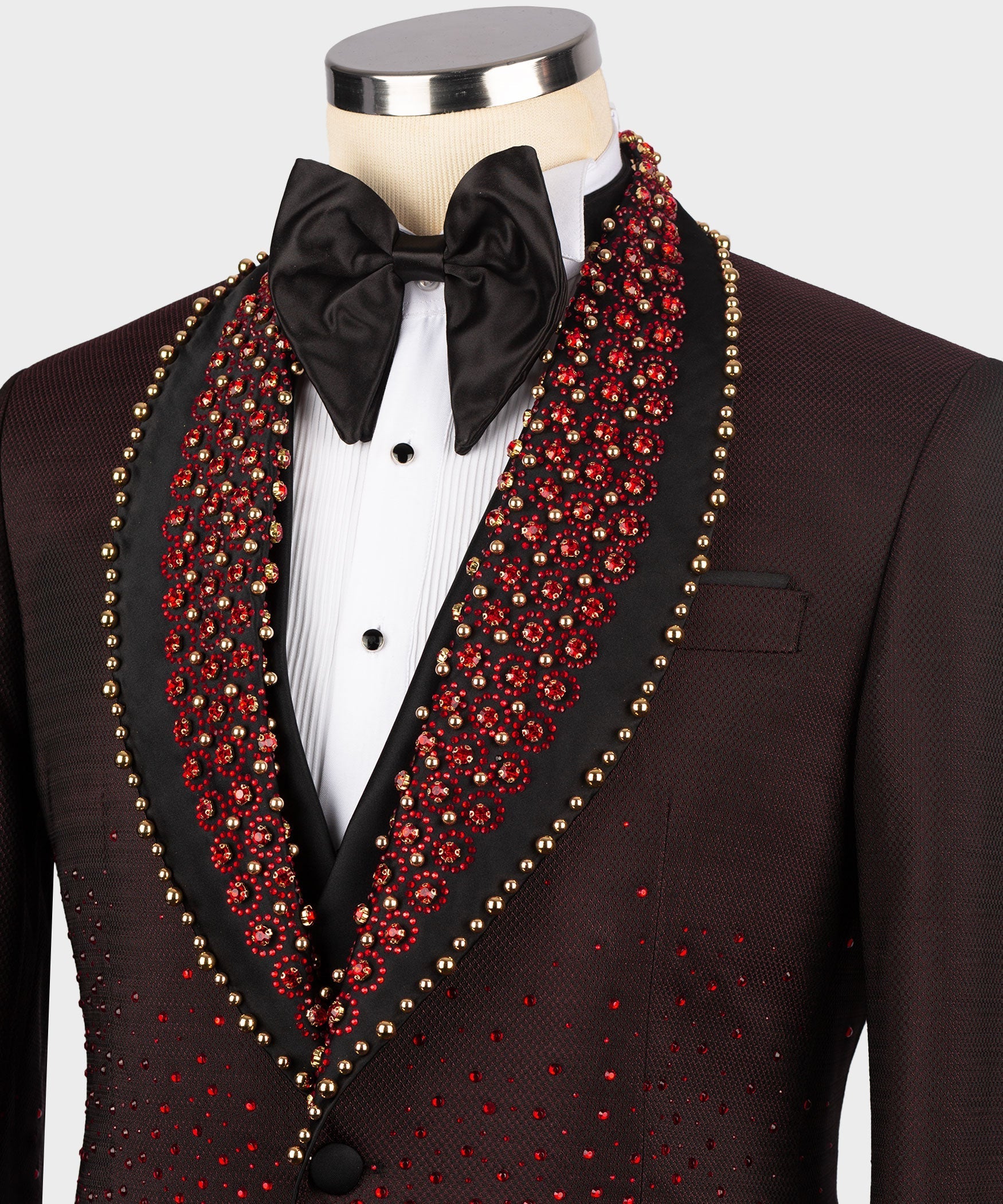 Burgundy tuxedo jacket close-up with black bow tie, red jeweled lapels, and breast pocket