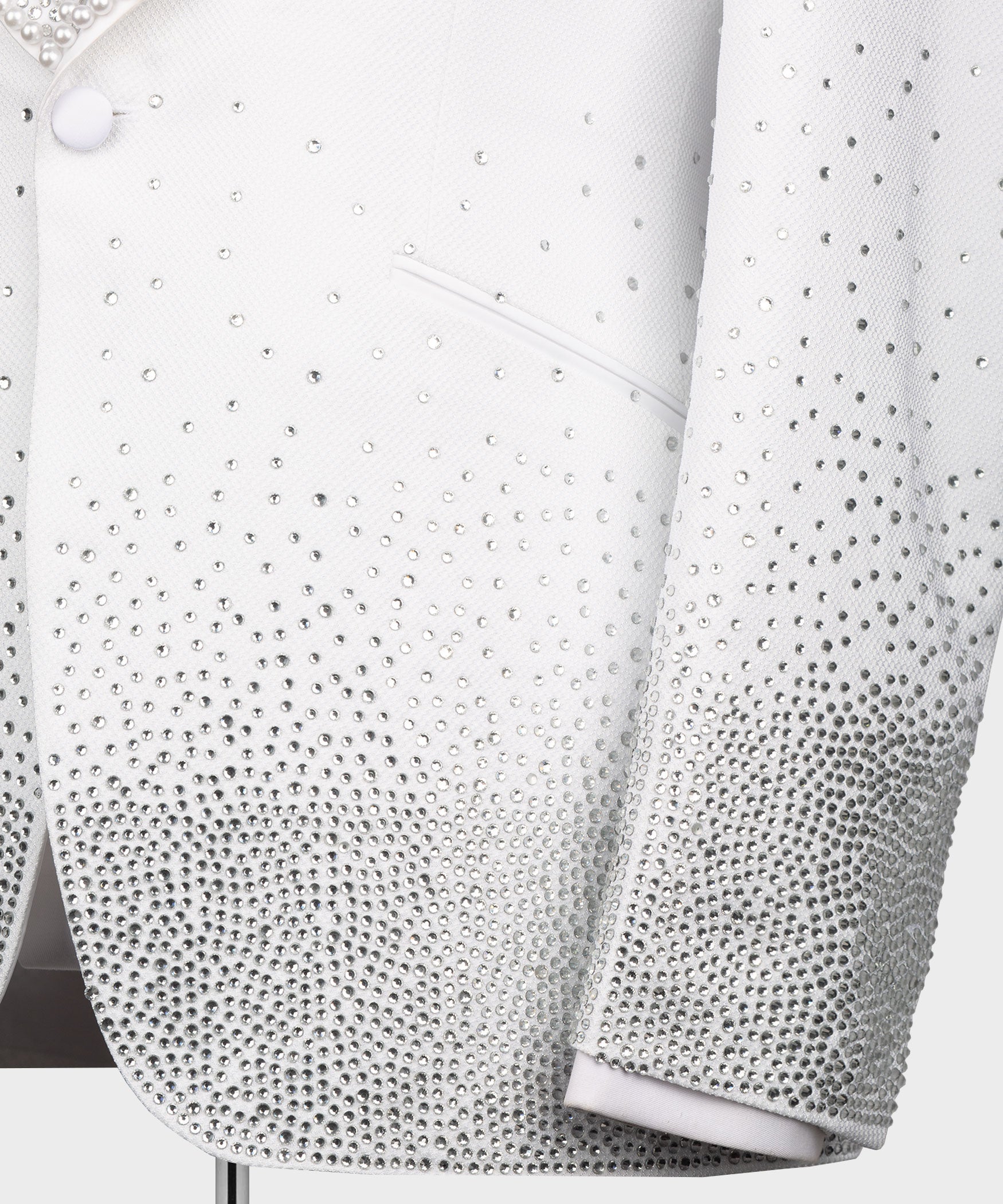 White tuxedo jacket front details with dense rhinestone beadwork on chest and sleeve