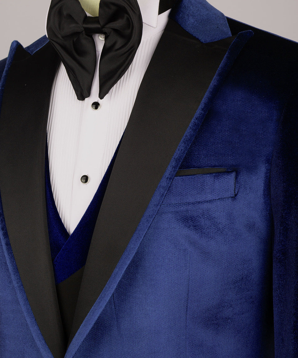 Close-up of black bow tie, white shirt, and blue satin-trim pocket on tux jacket