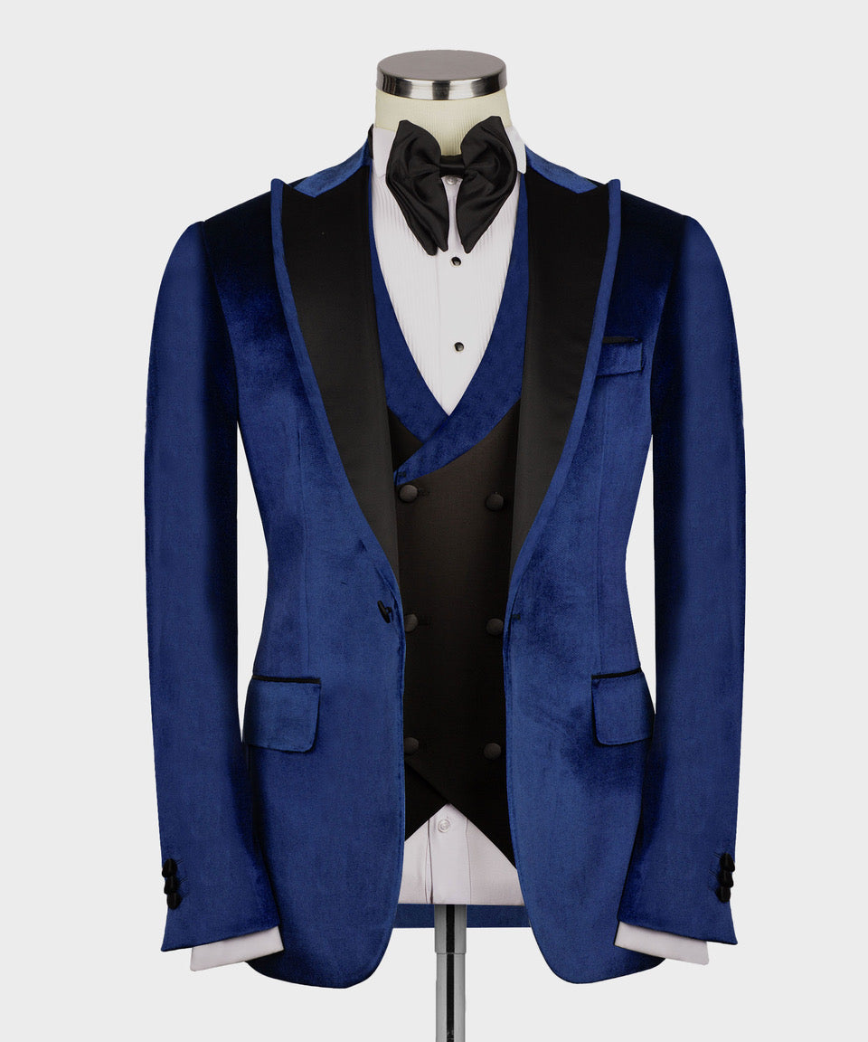 Blue velvet tuxedo jacket with satin collar, double-breasted vest, and black bow tie