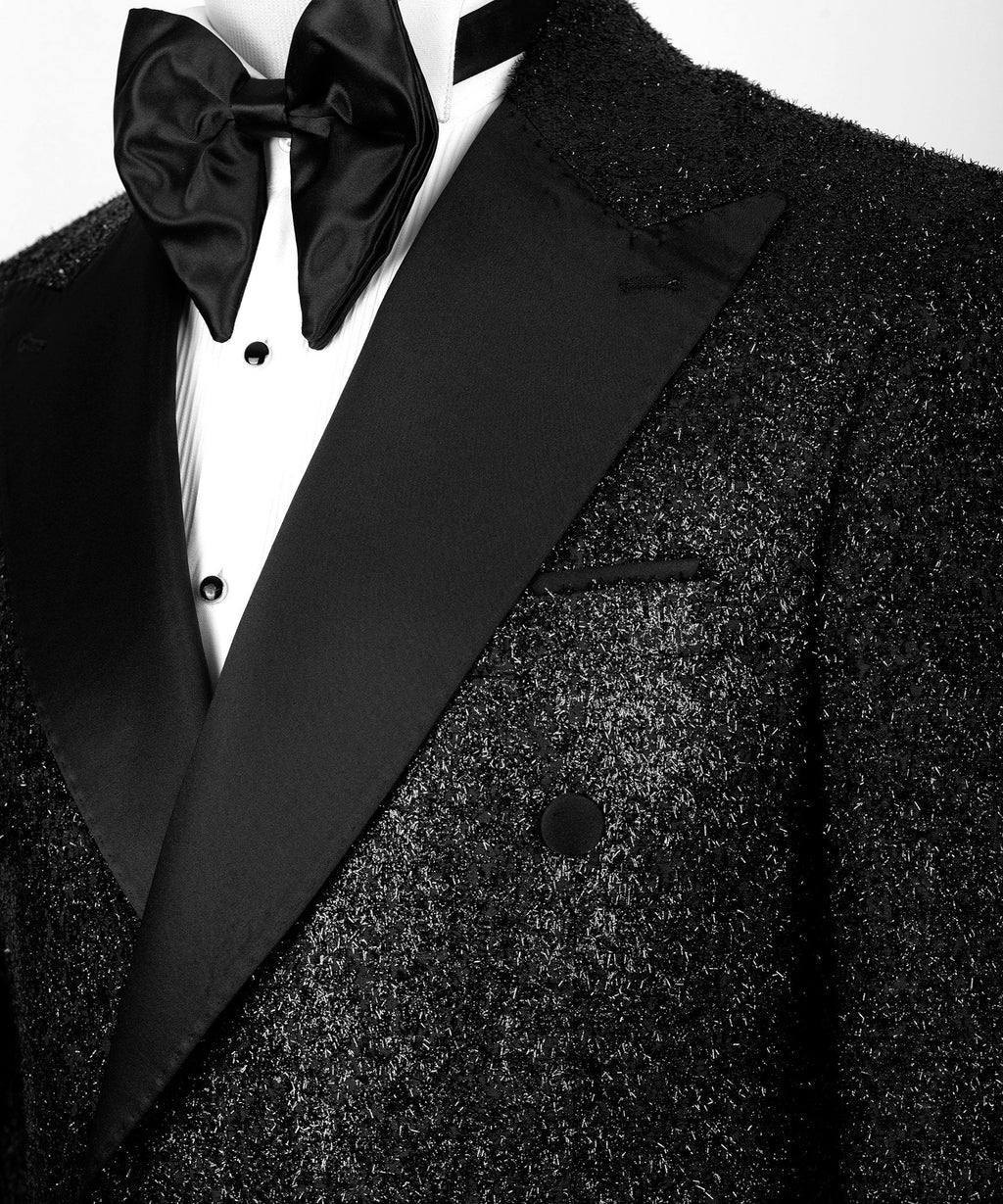 Black satin bow tie and peak lapel on black glitter tuxedo jacket, close-up