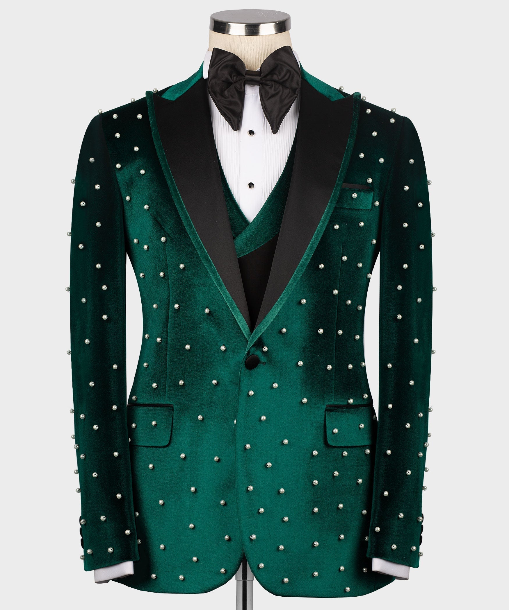 Green velvet tuxedo jacket with pearl studs, black bow tie and dress shirt