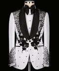 White tuxedo jacket with black shawl lapels, floral embroidery, and dotted embellishments