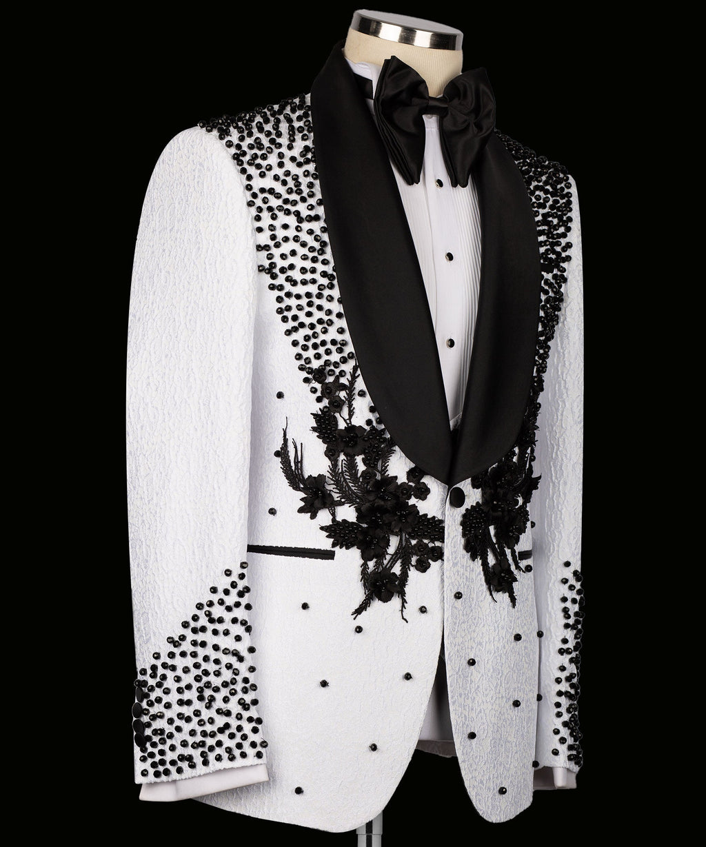 White tuxedo suit jacket with black shawl lapels and floral appliqué on the front