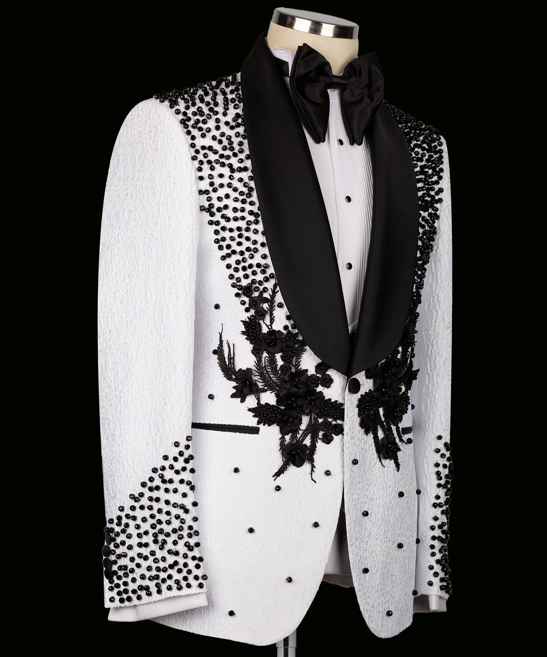 White tuxedo jacket front view with black floral embroidery on lapels and dotted accents